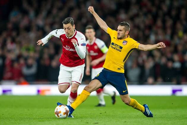 Mesut Ozil of Arsenal and Koke of Atletico Madrid during the UEFA Europa League Semi Final match between Arsenal and Atletico Madrid at the Emirates Stadium, London, England on 26 April 2018. Copyright: xSalvioxCalabresex 19780077