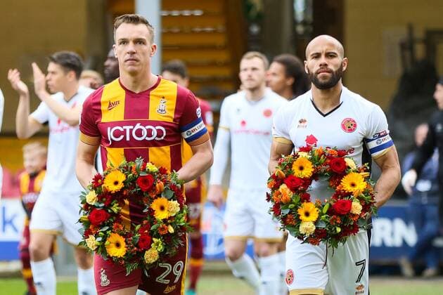 Tony McMahon of Bradford City and Adam Chambers of Walsall walk onto the pitch with Wreaths to honour the 56 people that lost their lives in the Bradford City Fire during the Sky Bet League 1 match between Bradford City and Walsall at the Northern Commercial Stadium, Bradford, England on 1 May 2018. Copyright: xThomasxGaddx PMI-2007-0003