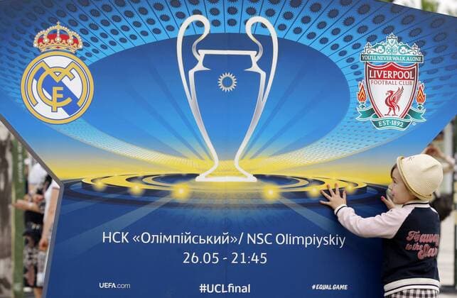 May 12, 2018 - Kiev, Ukraine - A child plays in front the installation with the logo of the UEFA Champions League final in centr of Kiev, Ukraine, on 12 May 2018. Kiev will host the UEFA Champions League Final matches on 24 and 26 May 2018. UKRAINE UEFA CHAMPIONS LEAGUE FINAL 2018 - ZUMAg194 20180512_zap_g194_001 Copyright: xSergxGlovnyx