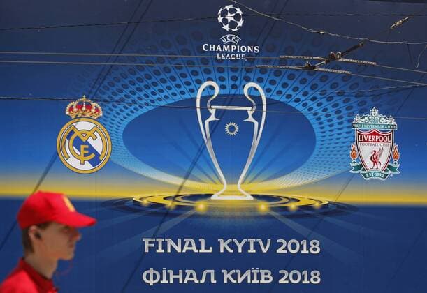 May 12, 2018 - Kiev, Ukraine - A man walks pass a banner with the logo of the UEFA Champions League final in centr of Kiev, Ukraine, on 12 May 2018. Kiev will host the UEFA Champions League Final matches on 24 and 26 May 2018. UKRAINE UEFA CHAMPIONS LEAGUE FINAL 2018 - ZUMAg194 20180512_zap_g194_004 Copyright: xSergxGlovnyx