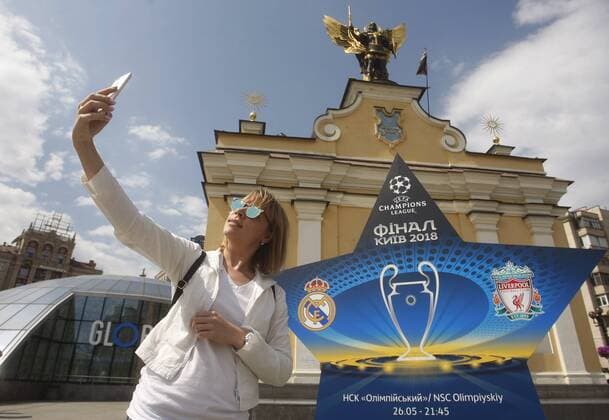 May 12, 2018 - Kiev, Ukraine - An Ukrainian woman pose for a selfie photo in front an installation with the logo of the UEFA Champions League final in centr of Kiev, Ukraine, on 12 May 2018. Kiev will host the UEFA Champions League Final matches on 24 and 26 May 2018. UKRAINE UEFA CHAMPIONS LEAGUE FINAL 2018 - ZUMAg194 20180512_zap_g194_005 Copyright: xSergxGlovnyx