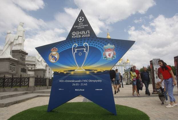 May 12, 2018 - Kiev, Ukraine - Ukrainians walk pass an installation with the logo of the UEFA Champions League final in centr of Kiev, Ukraine, on 12 May 2018. Kiev will host the UEFA Champions League Final matches on 24 and 26 May 2018. UKRAINE UEFA CHAMPIONS LEAGUE FINAL 2018 - ZUMAg194 20180512_zap_g194_013 Copyright: xSergxGlovnyx