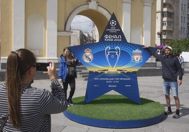 May 12, 2018 - Kiev, Ukraine - Ukrainians pose for a photo in front an installation with the logo of the UEFA Champions League final in centr of Kiev, Ukraine, on 12 May 2018. Kiev will host the UEFA Champions League Final matches on 24 and 26 May 2018. UKRAINE UEFA CHAMPIONS LEAGUE FINAL 2018 - ZUMAg194 20180512_zap_g194_015 Copyright: xSergxGlovnyx