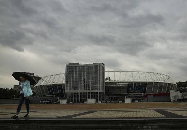 May 13, 2018 - Kiev, Ukraine - A woman walks near NSC Olimpiyskiy in Kyiv, Ukraine, May 13, 2018. Kyiv prepares to host UEFA Women s Champions League final between Wolfsburg and Lyon at Valeriy Lobanovskiy Dynamo Stadium on 24 May, 2018 and the UEFA Champions League final match between Real Madrid and Liverpool at NSC Olimpiyskiy Stadium on Saturday 26 May, 2018. Kyiv prepares for UEFA Champions League final  - ZUMAn230 20180513_zaa_n230_909 Copyright: xSergiixKharchenkox