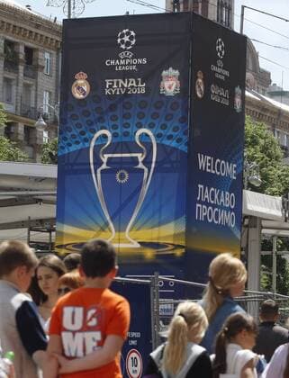 May 18, 2018 - Kiev, Ukraine - People walk in front of the UEFA Champions League Final 2018 logo, in center of Kiev, Ukraine, on 18 May 2018. Real Madrid will face Liverpool FC in the UEFA Champions League final at the NSC Olimpiyskiy stadium in Kiev on 26 May 2018. UKRAINE UEFA CHAMPIONS LEAGUE FINAL 2018 - ZUMAg194 20180518_zap_g194_009 Copyright: xSergxGlovnyx