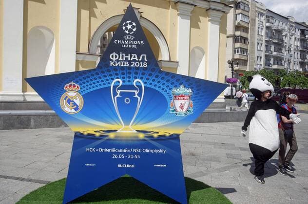 May 18, 2018 - Kiev, Ukraine - An animator dressed in a panda costume walks past an installation with the logo of the UEFA Champions League final, in center of Kiev, Ukraine, on 18 May 2018. Real Madrid will face Liverpool FC in the UEFA Champions League final at the NSC Olimpiyskiy stadium in Kiev on 26 May 2018. UKRAINE UEFA CHAMPIONS LEAGUE FINAL 2018 - ZUMAg194 20180518_zap_g194_014 Copyright: xSergxGlovnyx