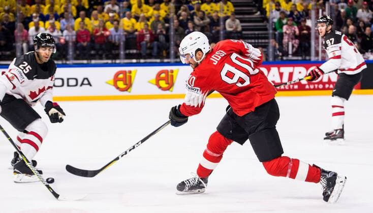 180519 Switzerland Joel Roman is shooting next to Canadas Darnell Nurse during the semi-finals of the ice hockey World Cup between Canada and Switzerland on May 19, 2018 in Copenhagen  Copyright: PETTERxARVIDSON BB180519PA131