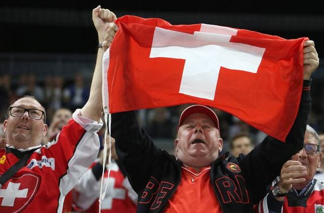 COPENHAGEN, DENMARK - MAY 19, 2018: Fans wave the Swiss flag in their team s 2018 IIHF World Championship WM Weltmeisterschaft semi-final match against Canada at Royal Arena in Copenhagen. AAlexander Demianchuk TASS  TS080301