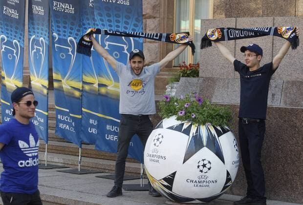 May 23, 2018 - Kiev, Ukraine - Real Madrid fans pose for a photo near a giant ball promoting the UEFA Champions League final in center of Kiev, Ukraine, on 23 May 2018. Real Madrid will face Liverpool FC in the UEFA Champions League final at the NSC Olimpiyskiy stadium in Kiev on 26 May 2018. UKRAINE UEFA CHAMPIONS LEAGUE FINAL 2018 - ZUMAg194 20180523_zap_g194_020 Copyright: xSergxGlovnyx