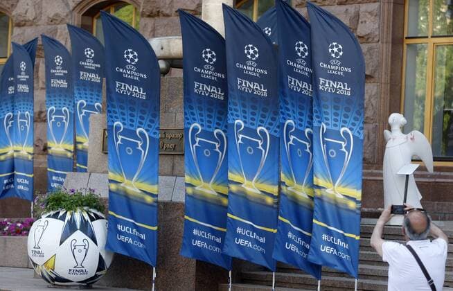 May 23, 2018 - Kiev, Ukraine - A man takes a photo of banners promoting the UEFA Champions League final in center of Kiev, Ukraine, on 23 May 2018. Real Madrid will face Liverpool FC in the UEFA Champions League final at the NSC Olimpiyskiy stadium in Kiev on 26 May 2018. UKRAINE UEFA CHAMPIONS LEAGUE FINAL 2018 - ZUMAg194 20180523_zap_g194_030 Copyright: xSergxGlovnyx