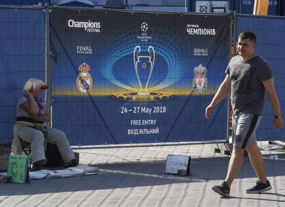 May 23, 2018 - Kiev, Ukraine - A man walks in front of the UEFA Champions League Final 2018 logo, in center of Kiev, Ukraine, on 23 May 2018. Real Madrid will face Liverpool FC in the UEFA Champions League final at the NSC Olimpiyskiy stadium in Kiev on 26 May 2018. UKRAINE UEFA CHAMPIONS LEAGUE FINAL 2018 - ZUMAg194 20180523_zap_g194_032 Copyright: xSergxGlovnyx