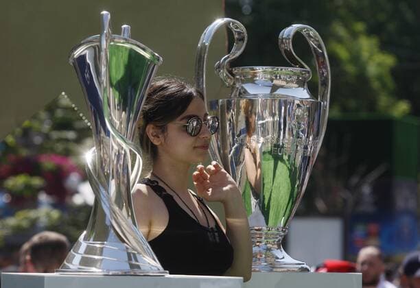 May 24, 2018 - Kiev, Ukraine - A girl poses for a photo with the Champions league trophies, during the opening ceremony of a Champions Festival in Kiev, Ukraine, on 24 May, 2018. Real Madrid will face Liverpool FC in the UEFA Champions League final at the NSC Olimpiyskiy stadium in Kiev on 26 May 2018. Real Madrid vs Liverpool FC - ZUMAg194 20180524_zap_g194_017 Copyright: xSergxGlovnyx