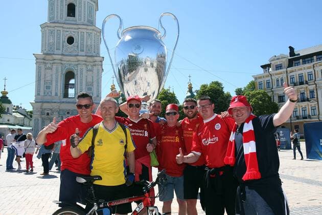 Real Madrid v Liverpool UEFA Champions League Final Liverpool fans and local fan wearing a Ukraine national team Nationalteam shirt in front of a giant Champions League Trophy before the UEFA Champions League Final at the Olympic Stadium, Kiev Content Not Available For UK Newspapers Copyright: xPaulxChestertonx FIL-11844-0028