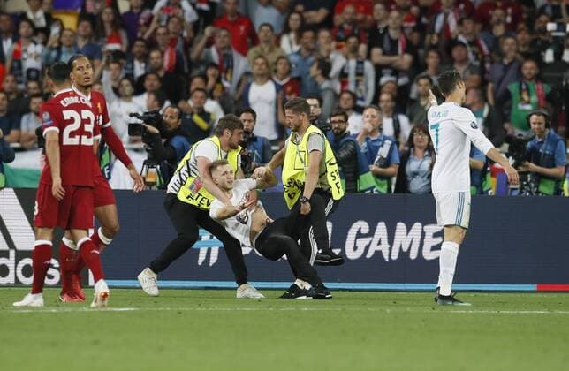 A fan runs onto the pitch as Cristiano Ronaldo of Real Madrid is about to shoot during the UEFA Champions League Final match at the NSK Olimpiyskiy Stadium, Kiev. Picture date 26th May 2018. Picture credit should read: David Klein Sportimage EDITORIAL USE ONLY. No use with unauthorised audio, video, data, fixture lists, club league logos or live services. Online in-match use limited to 120 images, no video emulation. No use in betting, games or single club league player publications.