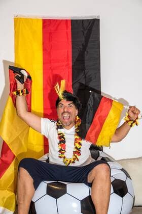 Euphoric football fan looks euphoric at Germany game on TV