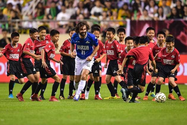 Bilder des Tages - SPORT Italian retired football player Andrea Pirlo, center, of International Legends challenges children in the 3V64 challenge during the 2018 Super Penguin Soccer Celebrity Game in Shanghai, China, 2 June 2018. Chinese Celebrity competes against International Legends during 2018 Super Penguin Soccer Celebrity Game  20180602_49696