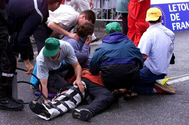 NO MAGS-NO SALES-NO INTERNET BRU08 - - COLMAR, FRANCE : French police help injured spectators lying on the ground in Colmar Saturday, 14 July 2001, after a car crashed into security barriers around the finishing line of the seventh stage of the Tour de France here on Saturday, witnesses said. The crash happened around 30 minutes after the riders crossed the line at the end of the Strasbourg to Colar stage in eastern France. The injured were taken to hospital and the driver of the car was accosted by police. The stage, watched by a large crowd on the French national holiday Bastille Day, was won by Frenchman Laurent Jalabert of the CSC team. MICHELxGOUVERNEUR  x673595x