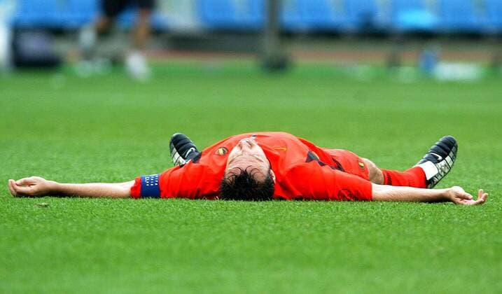 BRU40 - - SHIZUOKA, JAPAN : Red Devil Marc Wilmots lays on the field after winning the Group H first round last match Belgium-Russia of the 2002 FIFA World Cup WM Weltmeisterschaft Fussball in Korea and Japan, 14 June 2002 at Shizuoka Stadium. Belgium defeated Russia 3-2 and qualified for the second round. YVESxBOUCAU  x973140x