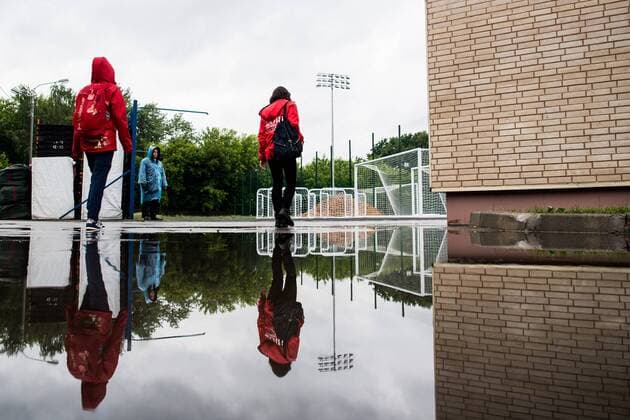 180612 Volunteers are reflected in a puddle after a heavy rain prior team Mexico practice session ahead of the 2018 FIFA World Cup on June 12, 2018 in Moscow Photo Petter Arvidson BILDBYR N Code PA 92060  Copyright: PETTERxARVIDSON BB180612PA062
