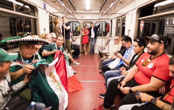 Moscow 17 06 2018 Couple watching fans in the Metro line 1 country and people