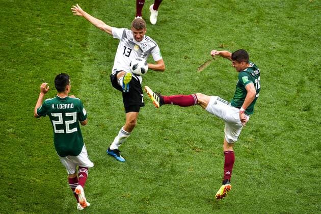 Thomas Mueller (Muller) of Germany, center, challenges Hector Moreno of Mexico in their Group F match during the FIFA World Cup WM Weltmeisterschaft Fussball 2018 in Moscow, Russia, 17 June 2018. Mexico takes lead in first half against Germany  20180617_55934
