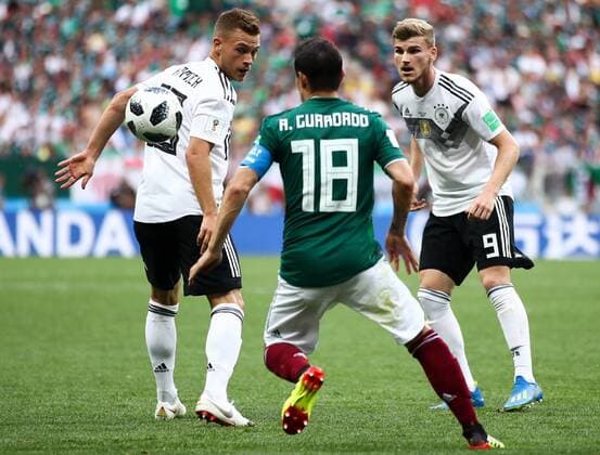 MOSCOW, RUSSIA - JUNE 17, 2018: Germany s Joshua Kimmich, Mexico s Andres Guardado, and Germany s Timo Werner (L-R) fight for the ball in their 2018 FIFA World Cup WM Weltmeisterschaft Fussball Group F football match at Luzhniki Stadium. Valery Sharifulin TASS  TS084C83