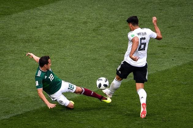 Andres Guardado of Mexico, left, challenges Sami Khedira of Germany in their Group F match during the 2018 FIFA World Cup WM Weltmeisterschaft Fussball in Moscow, Russia, 17 June 2018. Mexico won its World Cup opener, hanging on to defeat defending champion Germany 1-0 in Moscow. many  20180618_00211