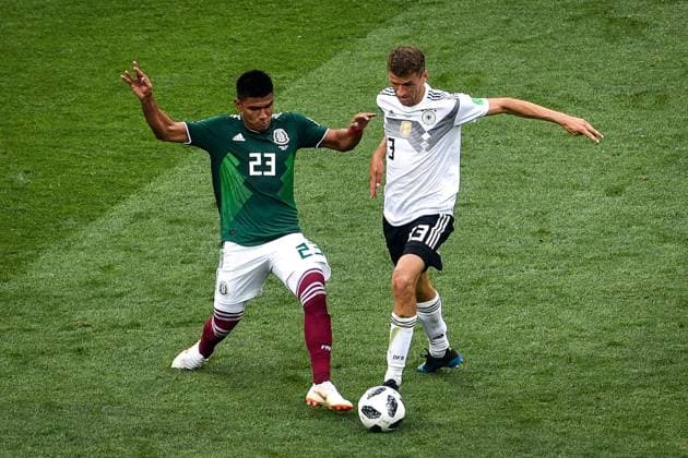 Jesus Gallardo of Mexico, left, challenges Thomas Muller (Mueller) of Germany in their Group F match during the 2018 FIFA World Cup WM Weltmeisterschaft Fussball in Moscow, Russia, 17 June 2018. Mexico won its World Cup opener, hanging on to defeat defending champion Germany 1-0 in Moscow. many  20180618_40227