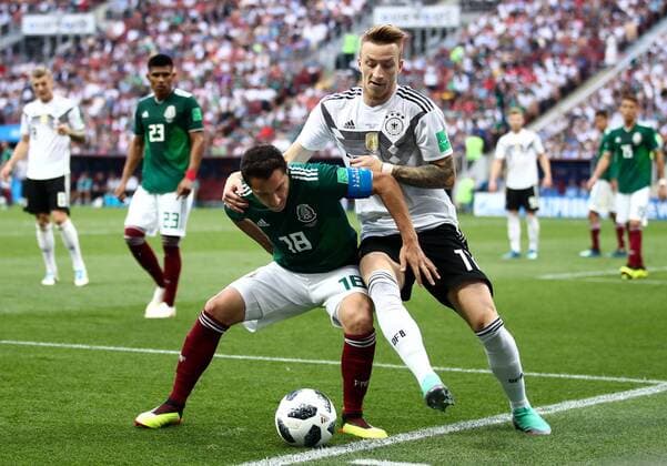 MOSCOW, RUSSIA - JUNE 17, 2018: Mexico s Andres Guardado (L) and Germany s Marco Reus fight for the ball in their 2018 FIFA World Cup WM Weltmeisterschaft Fussball Group F football match at Luzhniki Stadium. Mexico won the game 1-0. Valery Sharifulin TASS  TS084D2E