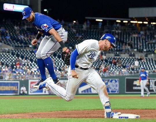 June 20, 2018 - Kansas City, MO, USA - Kansas City Royals Hunter Dozier reaches first as the throw to Texas Rangers third baseman Joey Gallo was high in the seventh inning on Wednesday, June 20, 2018, at Kauffman Stadium in Kansas City, Mo. Texas Rangers vs. Kansas City Royals - ZUMAm67_ 20180620_zaf_m67_074 Copyright: xJohnxSleezerx