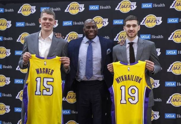 June 26, 2018 - Los Angeles, California, U.S - Los Angeles Lakers president of basketball operations, Earvin Magic Johnson, center, rookies Sviatoslav Mykhailiuk, right, and Moritz Wagner pose with their new jerseys at an introductory press conference PK Pressekonferenz in Los Angeles, Tuesday, June 26, 2018. The Lakers introduce two new draft players, Moritz Wagner, originally from Germany, the 25th pick in the 2018 NBA Basketball Herren USA Draft and guard Sviatoslav Mykhailiuk, originally from Ukraine. The Los Angeles Lakers introduces its 2018.Draft acquisitions - ZUMAc68_ 84056230st Copyright: xRingoxChiux