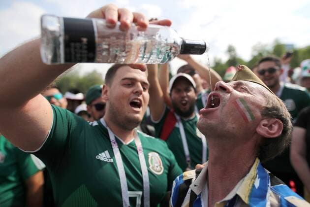 YEKATERINBURG, RUSSIA - JUNE 27, 2018: Supporters of Team Mexico drinking in a street ahead of a 2018 FIFA World Cup WM Weltmeisterschaft Fussball Group F match between Mexico and Sweden. Sergei Bobylev TASS  TS086A01