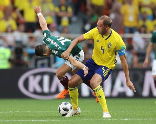 (180627) -- YEKATERINBURG, June 27, 2018 -- Javier Hernandez (L) of Mexico vies with Andreas Granqvist of Sweden during the 2018 FIFA World Cup WM Weltmeisterschaft Fussball Group F match between Mexico and Sweden in Yekaterinburg, Russia, June 27, 2018. ) (SP)RUSSIA-YEKATERINBURG-2018 WORLD CUP-GROUP F-MEXICO VS SWEDEN LuxJinbo 