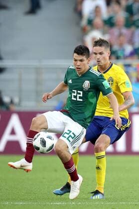 YEKATERINBURG, RUSSIA - JUNE 27, 2018: Mexico s Hirving Lozano (L) and Sweden s Mikael Lustig fight for the ball in their 2018 FIFA World Cup WM Weltmeisterschaft Fussball First Stage Group F football match at Ekaterinburg Arena Stadium. Sergei Bobylev TASS  TS086B00