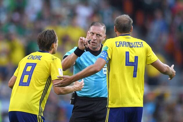 YEKATERINBURG, RUSSIA - JUNE 27, 2018: Sweden s Albin Ekdal, referee Nestor Pitana and Sweden s Andreas Granqvist (L-R) in the 2018 FIFA World Cup WM Weltmeisterschaft Fussball First Stage Group F football match between Mexico and Sweden at Ekaterinburg Arena Stadium. Donat Sorokin TASS  TS086B06