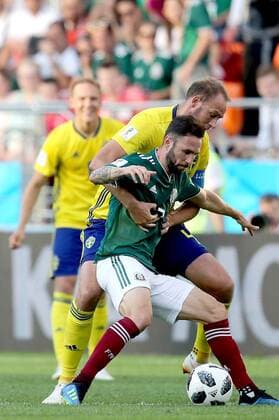 YEKATERINBURG, RUSSIA - JUNE 27, 2018: Mexico s Miguel Layun (L) and Sweden s Andreas Granqvist fight for the ball in their 2018 FIFA World Cup WM Weltmeisterschaft Fussball First Stage Group F football match at Ekaterinburg Arena Stadium. Sergei Bobylev TASS  TS086B12