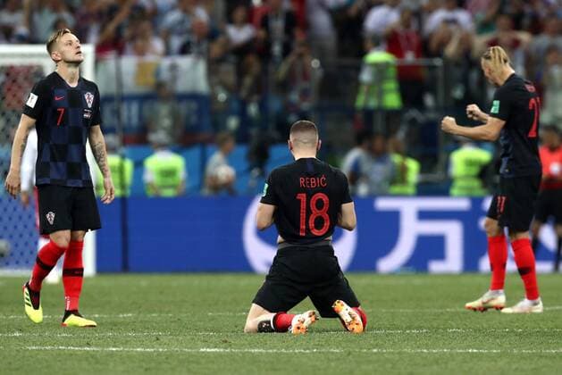 NIZHNY NOVGOROD, RUSSIA - JULY 1, 2018: Croatia s Ivan Rakitic, Ante Rebic and Domagoj Vida (L-R) celebrate their victory in the 2018 FIFA World Cup WM Weltmeisterschaft Fussball Round of 16 football match against Denmark at Nizhny Novgorod Stadium. Stanislav Krasilnikov TASS  TS08781B