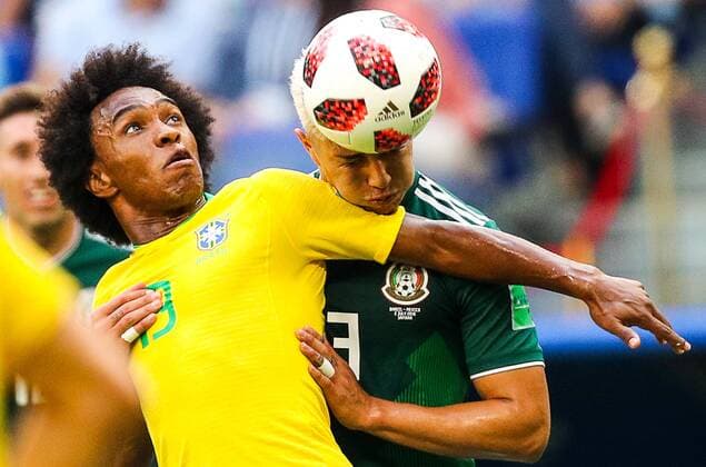 SAMARA, RUSSIA - JULY 2, 2018: Brazilâ€™s Willian (L) and Mexicoâ€™s Carlos Salcedo struggle for Telstar Mechta, the official match ball, in their 2018 FIFA World Cup WM Weltmeisterschaft Fussball Round of 16 match at Samara Arena Stadium. Sergei Bobylev TASS  TS087952