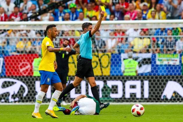 SAMARA, RUSSIA - JULY 2, 2018: Brazilâ€™s Neymar and referee Gianluca Rocchi (L-R standing) showing the yellow card to Brazil s Filipe Luis in their 2018 FIFA World Cup WM Weltmeisterschaft Fussball Round of 16 match against Mexico at Samara Arena Stadium. Sergei Savostyanov TASS  TS08796F