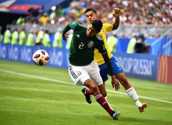 Philippe Coutinho of Brazil, back, challenges Hugo Ayala of Mexico in their Round of 16 match during the 2018 FIFA World Cup WM Weltmeisterschaft Fussball in Samara, Russia, 2 July 2018. Brazil has roared into the World Cup quarter-finals with a 2-0 victory over Mexico as Neymar shone with a goal and an assist that dumped the central Americans out at the last 16 stage for the seventh straight occasion. The PSG forward slid home in the second half and then teed up Roberto Firmino late on as the five-times champions beat an otherwise stubborn Mexico, whose World Cup began with such promise with a victory over champions Germany, but ended in familiar fashion in the first knockout round. Brazil beats Mexico 2-0 to progress as Neymar shows his brilliant best and frustrating worst  20180703_01677