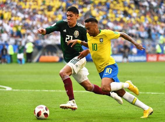 Neymar of Brazil, right, challenges Edson Alvarez of Mexico in their Round of 16 match during the 2018 FIFA World Cup WM Weltmeisterschaft Fussball in Samara, Russia, 2 July 2018. Brazil has roared into the World Cup quarter-finals with a 2-0 victory over Mexico as Neymar shone with a goal and an assist that dumped the central Americans out at the last 16 stage for the seventh straight occasion. The PSG forward slid home in the second half and then teed up Roberto Firmino late on as the five-times champions beat an otherwise stubborn Mexico, whose World Cup began with such promise with a victory over champions Germany, but ended in familiar fashion in the first knockout round. Brazil beats Mexico 2-0 to progress as Neymar shows his brilliant best and frustrating worst  20180703_21521