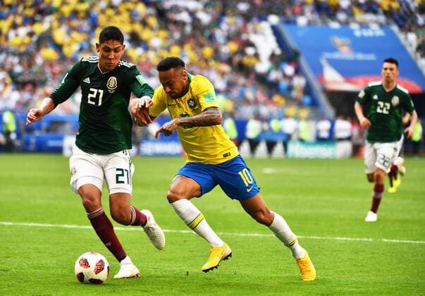 Neymar of Brazil, right, challenges Edson Alvarez of Mexico in their Round of 16 match during the 2018 FIFA World Cup WM Weltmeisterschaft Fussball in Samara, Russia, 2 July 2018. Brazil has roared into the World Cup quarter-finals with a 2-0 victory over Mexico as Neymar shone with a goal and an assist that dumped the central Americans out at the last 16 stage for the seventh straight occasion. The PSG forward slid home in the second half and then teed up Roberto Firmino late on as the five-times champions beat an otherwise stubborn Mexico, whose World Cup began with such promise with a victory over champions Germany, but ended in familiar fashion in the first knockout round. Brazil beats Mexico 2-0 to progress as Neymar shows his brilliant best and frustrating worst  20180703_21534