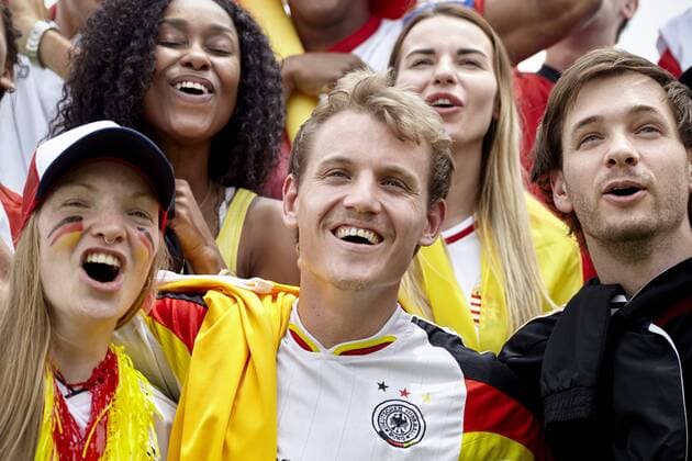 German football supporters cheering at match  Copyright: BelenxMajdalani B17060738