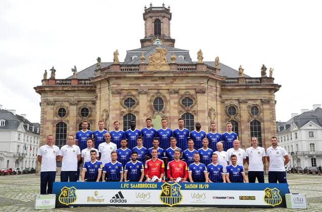 The team of the 1 FC Saarbrücken on Thursday 12 07 2018 in front of the Ludwigskirche in Saarbrücken In the picture Upper row from Marco Holz 14 Macel Carl 22 Steven Zellner 5 Alexandre Mendy 4 Benjamin Kessel 15 Oliver Oschkenat 3 Nino Miotke 28 Jose Pierre Vunguidica 9 Sebastian Jacob 24 and Marco Kehl Gomez Intermediate Series Robert Roelofsen Co Trainer Dirk Lottner Head Coach Christoph Fuhr Athletic Trainer Heinz Böhmann Goalkeeper Coach Gillian Jurcher 21 Lukas Quirin 31 Markus Obernosterer 10 Manuel Zeitz 8 Tobias Jänicke 25 Pierre Fassnacht 29 Helmut Schwan Supervisor Rüdiger Schmid Kit Officer Paulo da Palma Physiotherapist and Frank Kackert Goalkeeper Coach Bottom row by Fatih Köksal 27 Sascha Wenninger 19 Fanol Perdedaj 17 Ricco Cymer 20 Daniel Batz 1 Martin Dausch 7 Markus Mendler 11 and Mario Müller 23