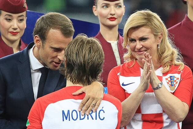 MOSCOW, RUSSIA â€“ JULY 15, 2018: France s President Emmanuel Macron (L) and Croatia s President Kolinda Grabar-Kitarovic (R) congratulate Croatia s forward Luka Modric (C) on winning the Ballon d Or at a victory ceremony after the 2018 FIFA World Cup WM Weltmeisterschaft Fussball final football match between France and Croatia at Luzhniki Stadium. Team France won the game 4:2 and claimed the World Cup title. Sergei Bobylev TASS  TS089A59