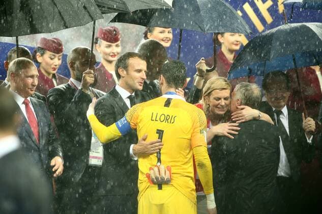 Vladimir Putin RUS President President Emmanuel Macron FRA Goalkeeper Hugo Lloris President Kolinda Grabar Kitarovic CRO Presentation ceremony in the rain World Champion Champion Champion Winner Soccer Football FIFA World Cup Russia Russia 2018 Final Season 2017 2018 15 07 2018 France FRA vs Croatia CRO