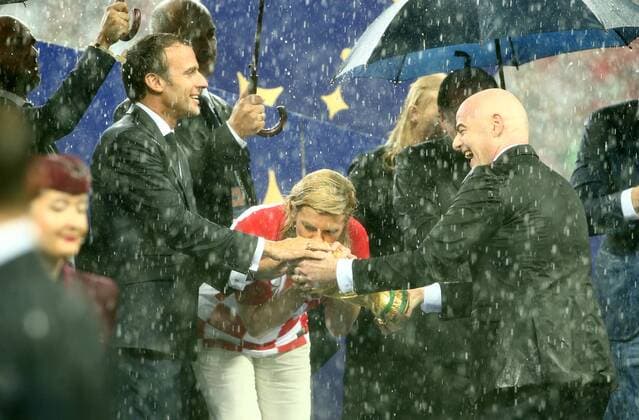 President Emmanuel Macron President Kolinda Grabar Kitarovic FIFA President Gianni Infantino with World Cup trophy in the pouring rain Sport Football Soccer FIFA World Cup Russia Russia 2018 Final Season 2017 2018 15 07 2018 France FRA vs Croatia CRO