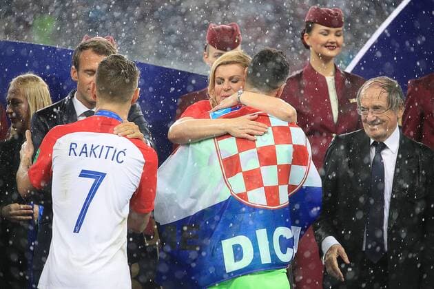MOSCOW, RUSSIA â€“ JULY 15, 2018: France s President Emmanuel Macron, Croatia s President Kolinda Grabar-Kitarovic, and French Football Federation (FFF) President Noel Le Graet (L-R back) present Croatian players with silver medals at a victory ceremony after the 2018 FIFA World Cup WM Weltmeisterschaft Fussball final football match between France and Croatia at Luzhniki Stadium. Team France won the game 4:2 and claimed the World Cup title. Sergei Bobylev TASS  TS089ABB