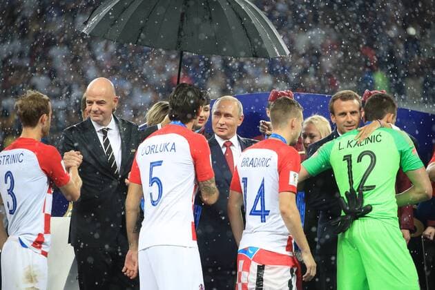 MOSCOW, RUSSIA â€“ JULY 15, 2018: FIFA President Gianni Infantino, Russia s President Vladimir Putin, and France s President Emmanuel Macron (L-R back) present Croatian players with silver medals at a victory ceremony after the 2018 FIFA World Cup WM Weltmeisterschaft Fussball final football match between France and Croatia at Luzhniki Stadium. Team France won the game 4:2 and claimed the World Cup title. Sergei Bobylev TASS  TS089AB7