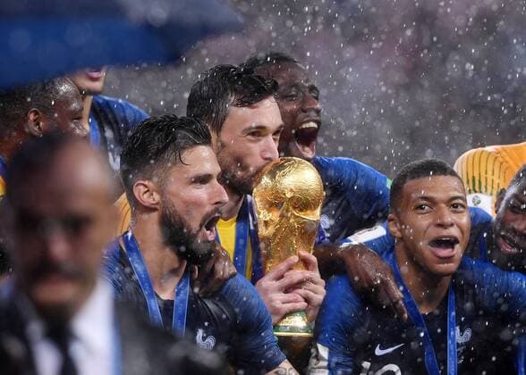 FIFA World Cup 2018 Final 15 07 2018 France Croatia Award ceremony World Champion France Goalkeeper Hugo Lloris Center kisses the World Cup trophy Olivier Giroud li and Kylian Mbappe re cheer